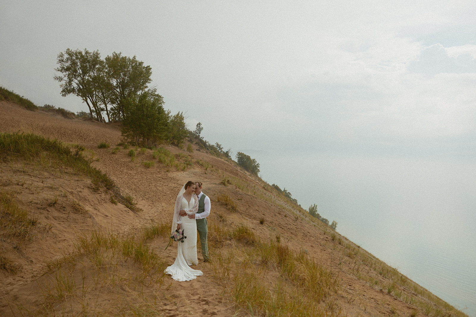 Couple on their wedding day at Pierce Stocking Overlook in Sleeping Bear Dunes