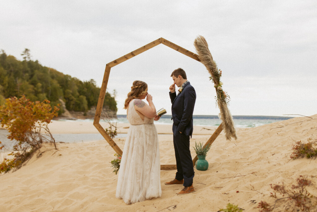 Eloping Couple under a hexagon arch on Miner's Beach in Pictured Rocks National Lakeshore