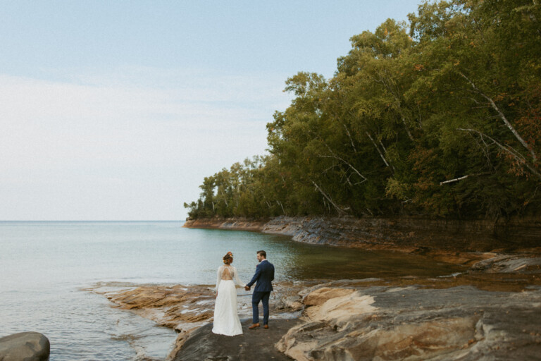 bride and groom eloping on the rocks in pictured rocks national lakeshore